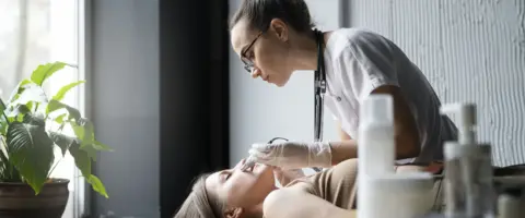 Estudiante aprende técnicas de belleza. Titulación y empleo en estética.